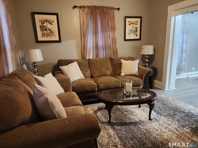 a living room with furniture and a rug