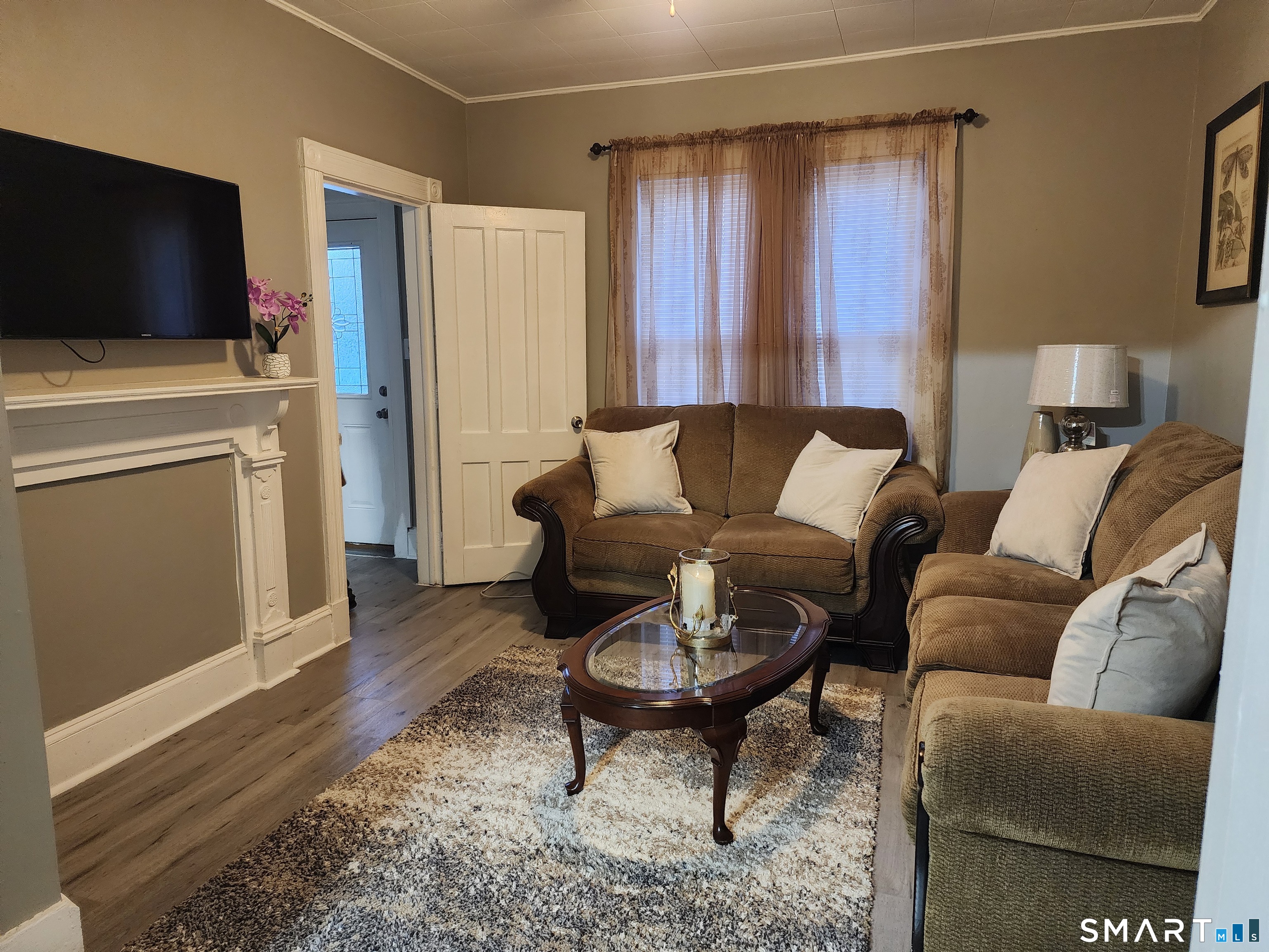 158 North Main Street Ansonia, CT 06401 - Photo 3 of 20 a living room with furniture and a flat screen tv