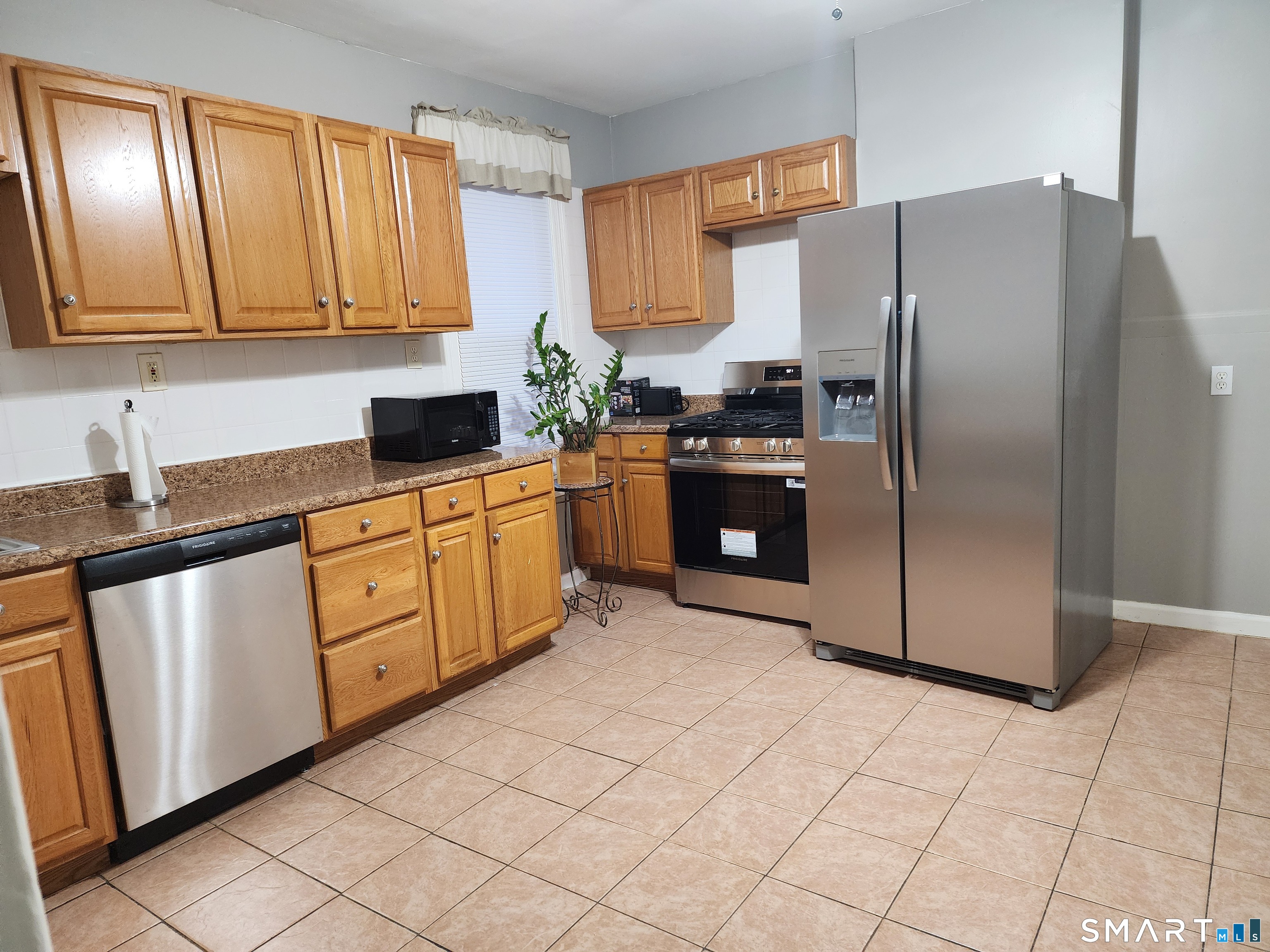 158 North Main Street Ansonia, CT 06401 - Photo 5 of 20 a kitchen with stainless steel appliances granite countertop a refrigerator sink and cabinets