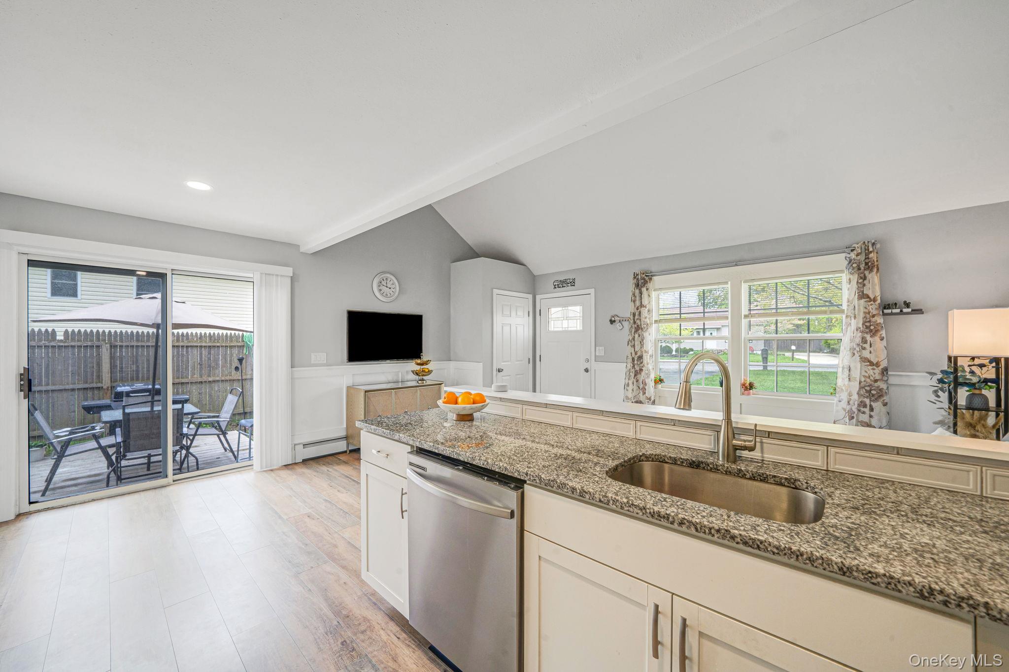 332 Commack Road Shirley, NY 11967 - Photo 11 of 25 a kitchen with stainless steel appliances granite countertop a sink and a wooden cabinets