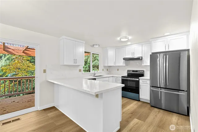 a kitchen with a refrigerator and a sink