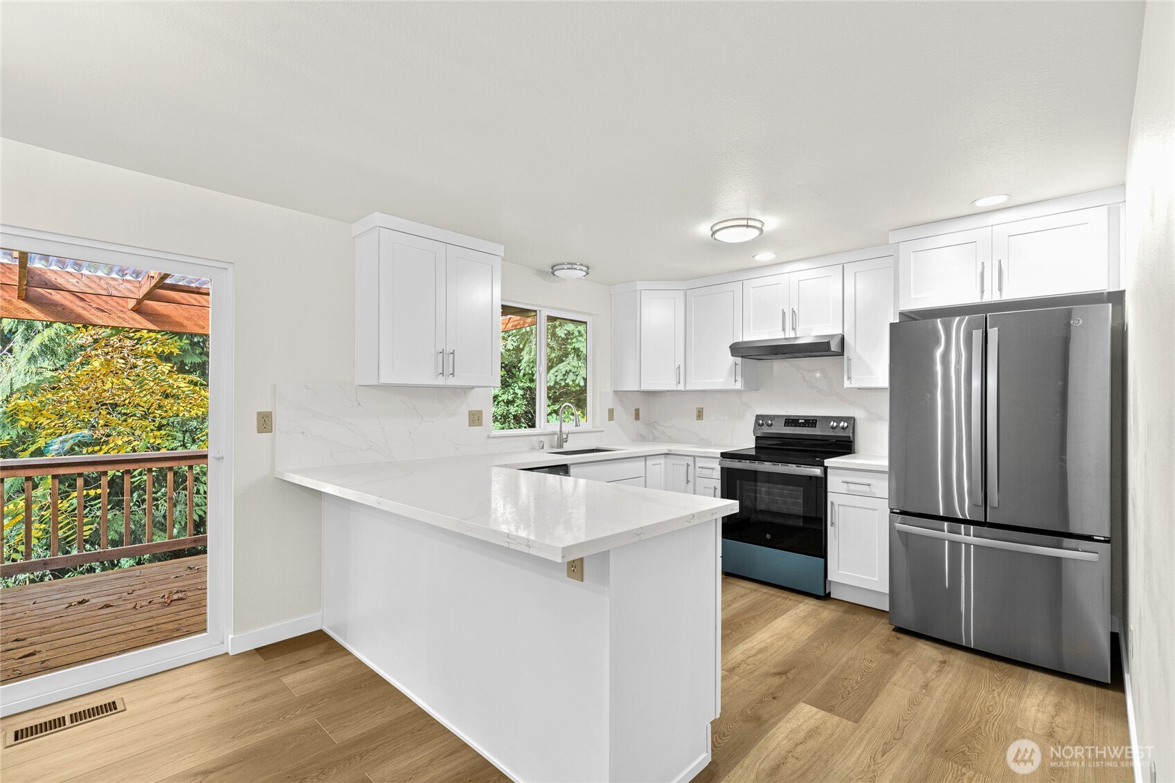 12718 Southeast 184th Place Renton, WA 98058 - Photo 13 of 34 a kitchen with a refrigerator and a sink
