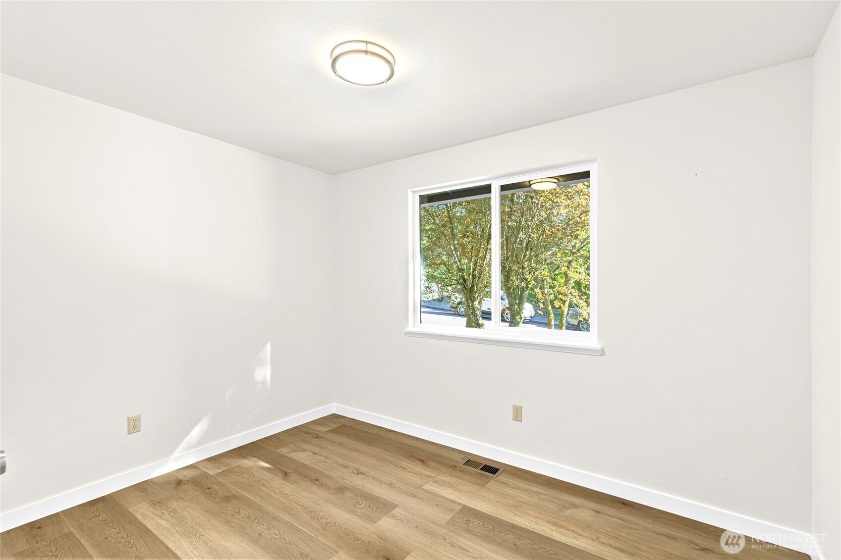 12718 Southeast 184th Place Renton, WA 98058 - Photo 20 of 34 an empty room with wooden floor and windows