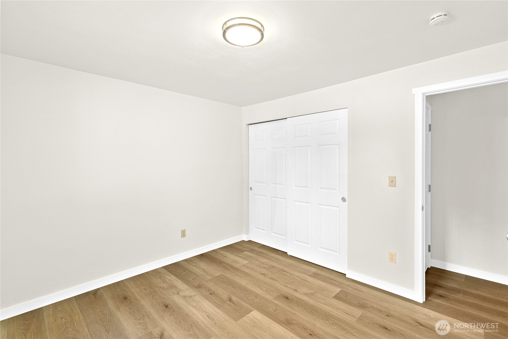 12718 Southeast 184th Place Renton, WA 98058 - Photo 23 of 34 a view of a room with wooden floor and white walls