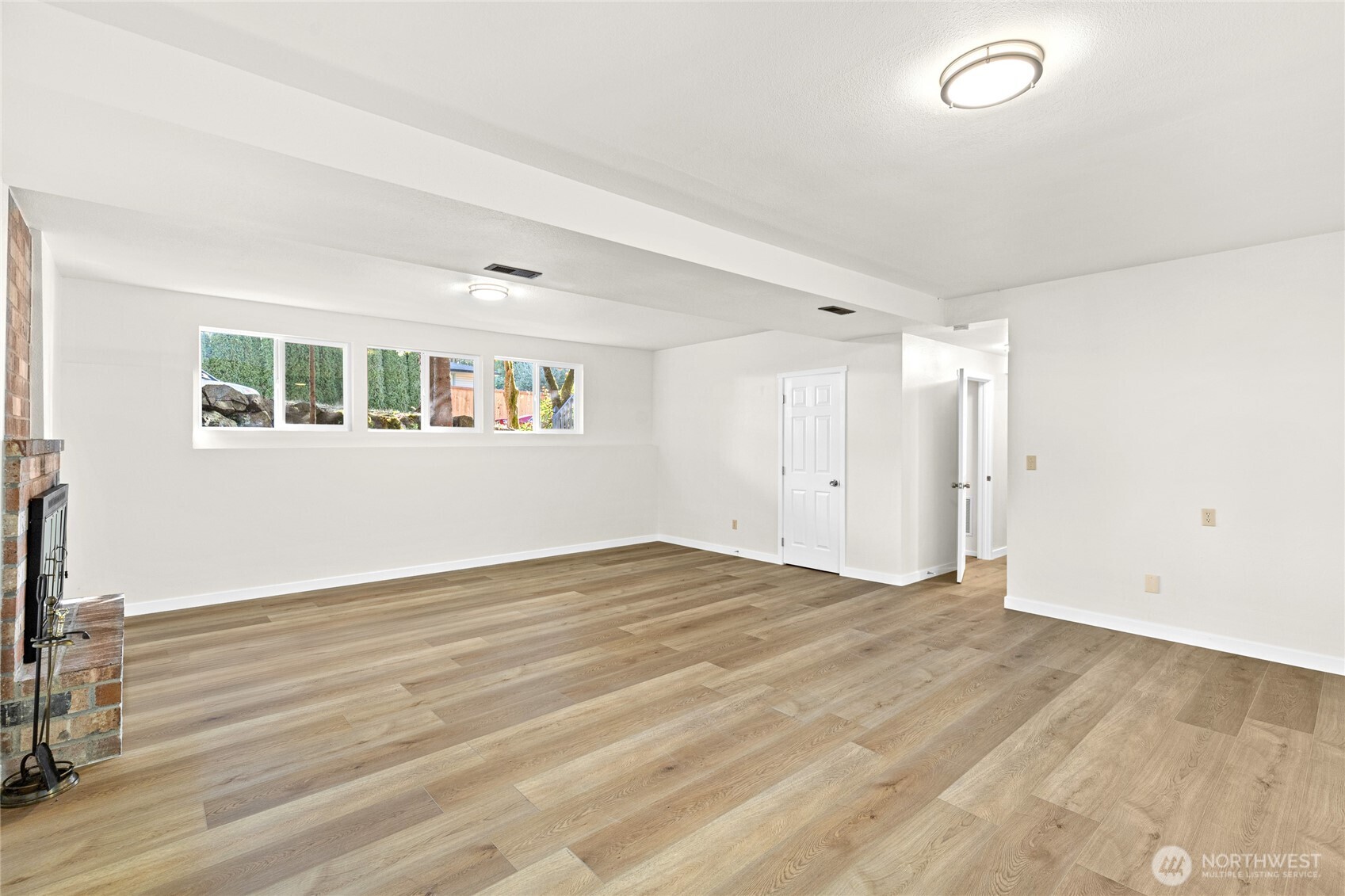 12718 Southeast 184th Place Renton, WA 98058 - Photo 26 of 34 a view of an empty room with wooden floor and a window