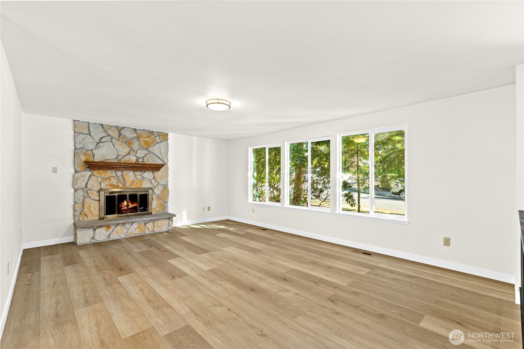 12718 Southeast 184th Place Renton, WA 98058 - Photo 7 of 34 a view of an empty room with a fireplace and a window