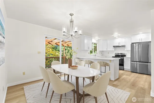 a view of a dining room with furniture window and wooden floor