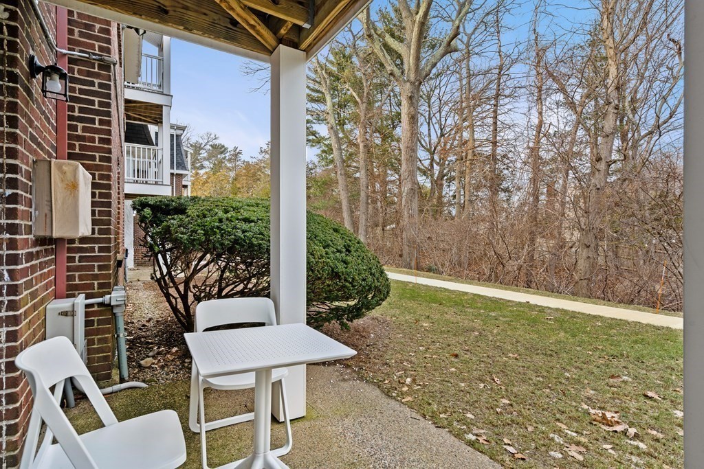 47 Will Drive, Unit 105 Canton, MA 02021 - Photo 2 of 13 a view of a chairs and table in the patio