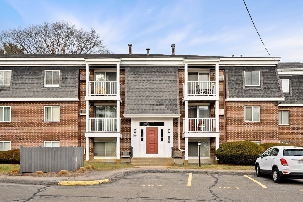 47 Will Drive, Unit 105 Canton, MA 02021 - Photo 3 of 13 a view of a car parked in front of a building
