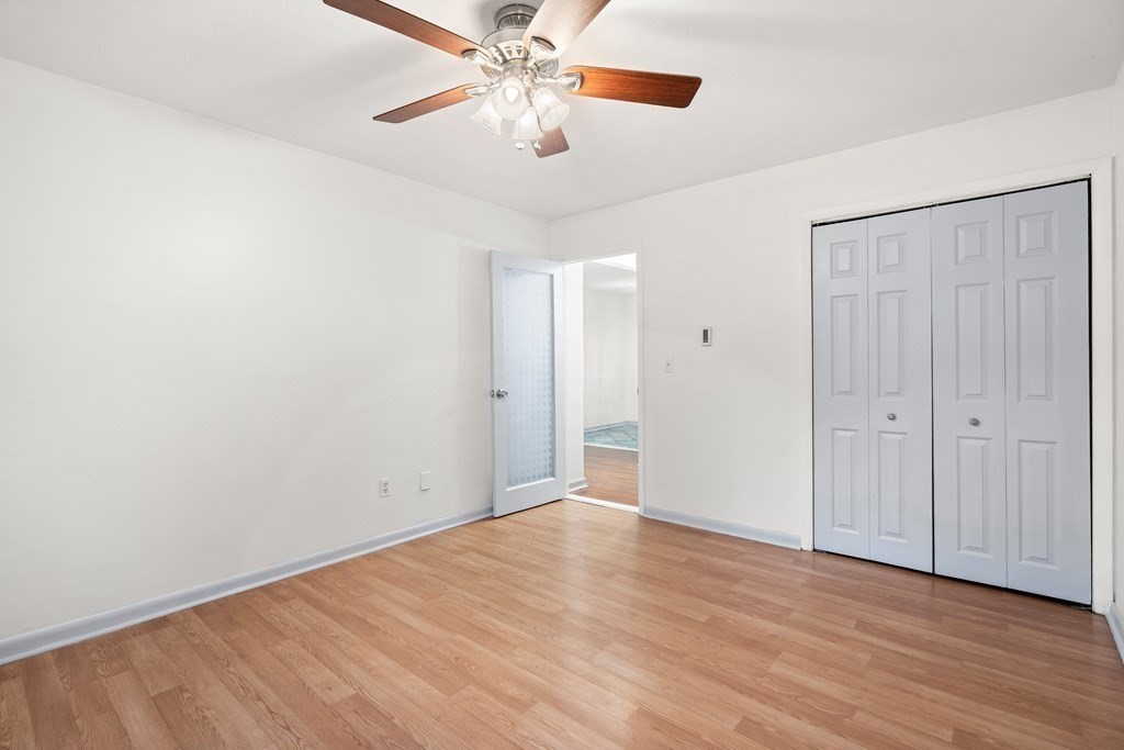 47 Will Drive, Unit 105 Canton, MA 02021 - Photo 7 of 13 a view of an empty room with wooden floor