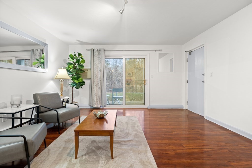 47 Will Drive, Unit 105 Canton, MA 02021 - Photo 10 of 13 a living room with furniture and a potted plant