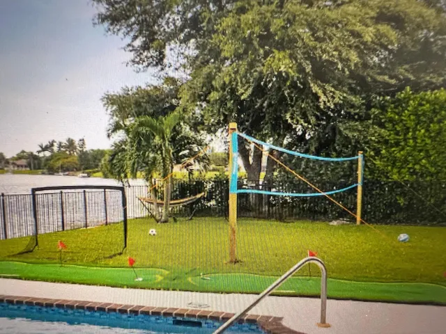 a view of a swimming pool with lounge chairs