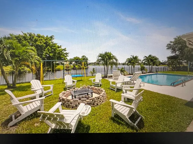 a kitchen with a granite countertop sink and a window