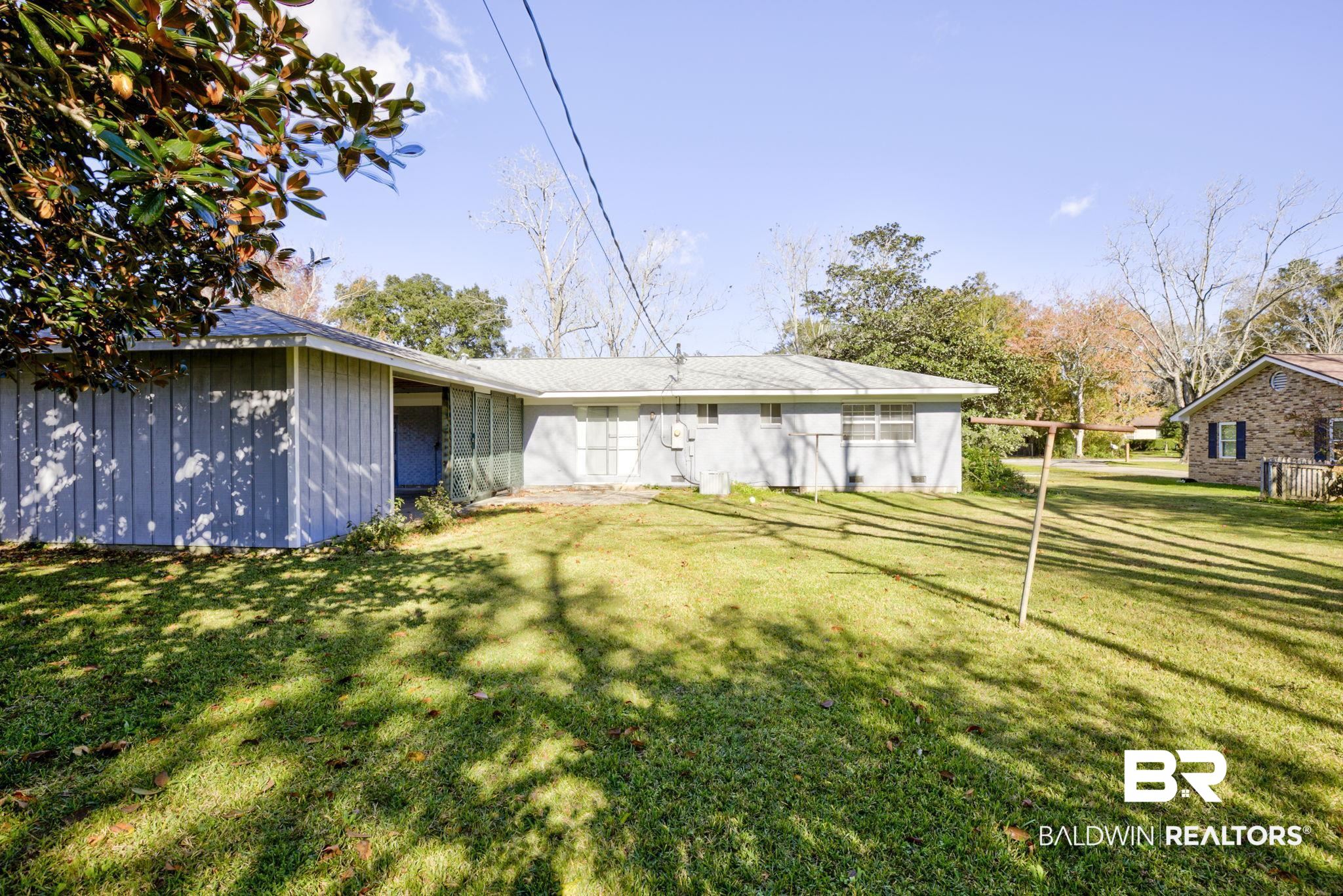 606 East Myrtle Avenue Foley, AL 36535 - Photo 21 of 24 Back of house featuring a lawn