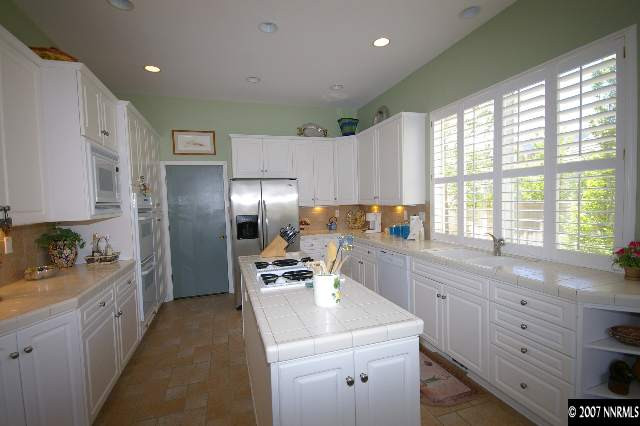 1865 Hunter Creek Road Reno, NV 89519 - Photo 4 of 9 a kitchen with a sink stove and refrigerator