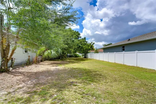 an aerial view of multiple houses with a yard