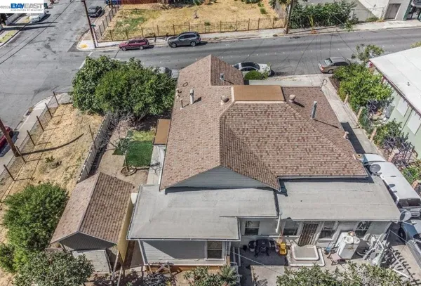an aerial view of a house with yard and patio