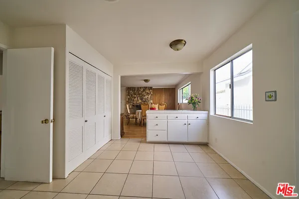 a large white kitchen with a stove a sink dishwasher and a refrigerator