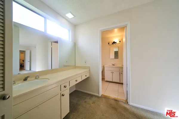 a bathroom with a sink a mirror and a bathtub