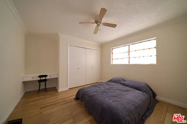 a bed sitting in a room next to a window