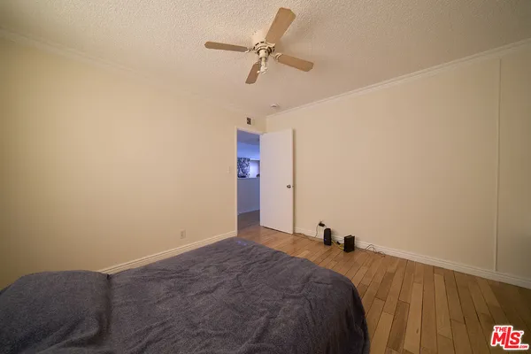 a bed room with a bed and a ceiling fan