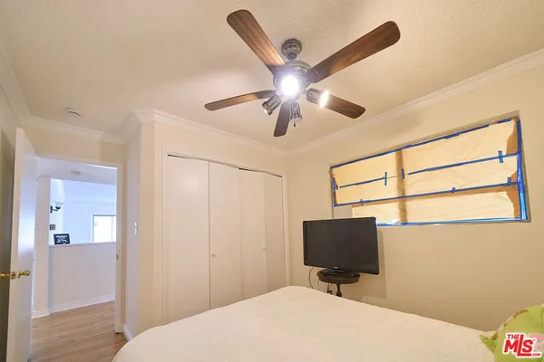 a bedroom with a bed and a flat screen tv