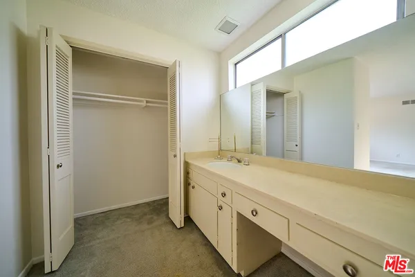 a bathroom with a double vanity sink and mirror