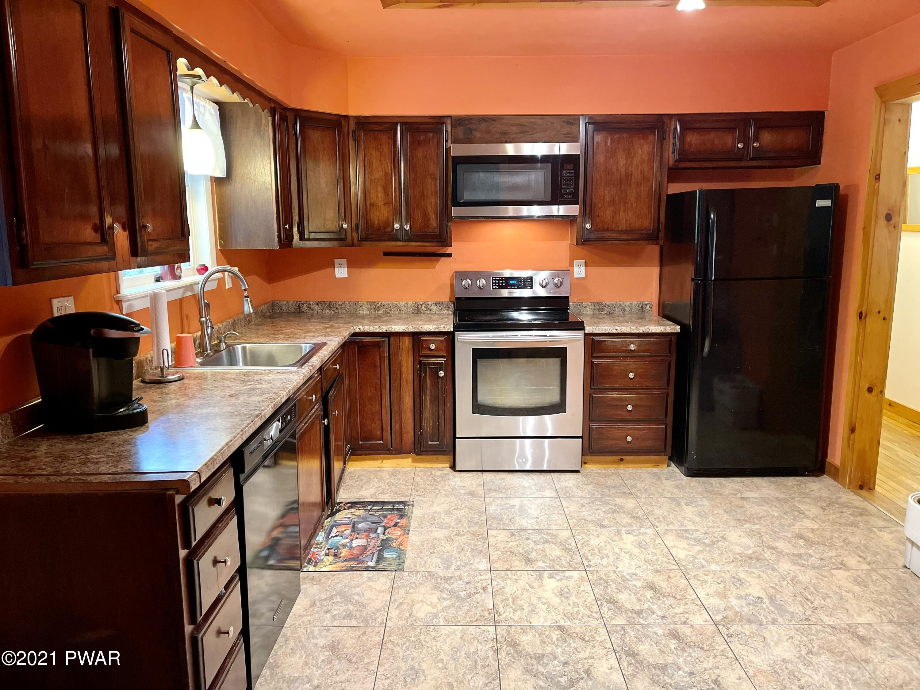 127 Estates Road Greentown, PA 18426 - Photo 52 of 85 a kitchen with stainless steel appliances granite countertop a refrigerator stove and sink