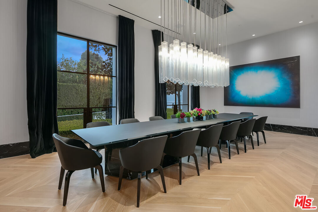 10701 Bellagio Road Los Angeles, CA 90077 - Photo 15 of 36 a dining hall with furniture a rug and a chandelier