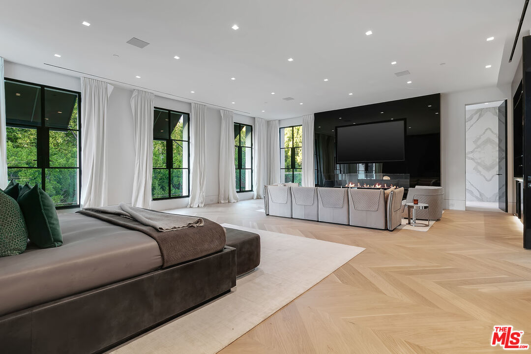 10701 Bellagio Road Los Angeles, CA 90077 - Photo 23 of 36 a living room with furniture and a flat screen tv
