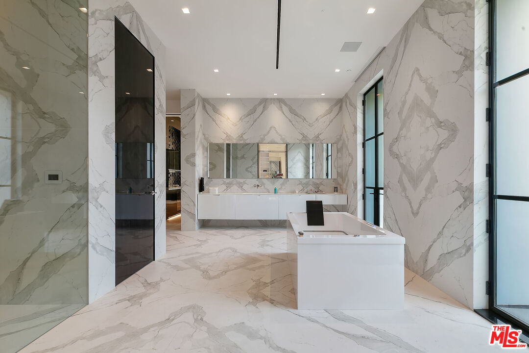 10701 Bellagio Road Los Angeles, CA 90077 - Photo 24 of 36 a view of a hallway with a sink and a mirror