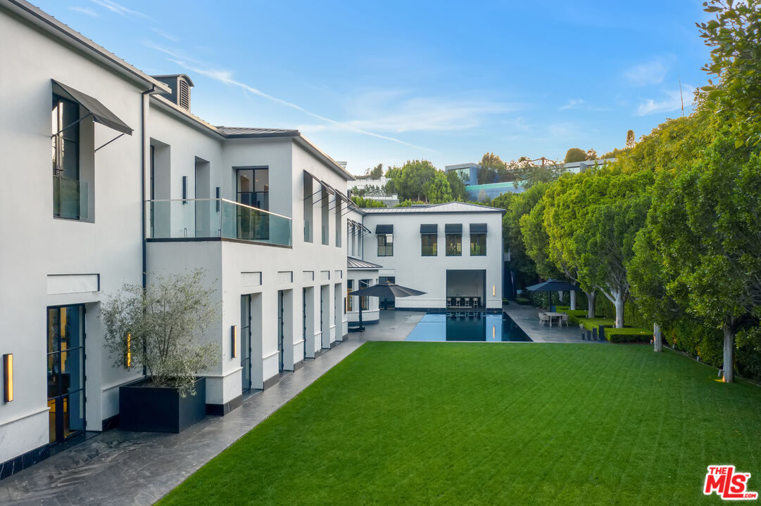 10701 Bellagio Road Los Angeles, CA 90077 - Photo 28 of 36 a view of a house with a yard and deck
