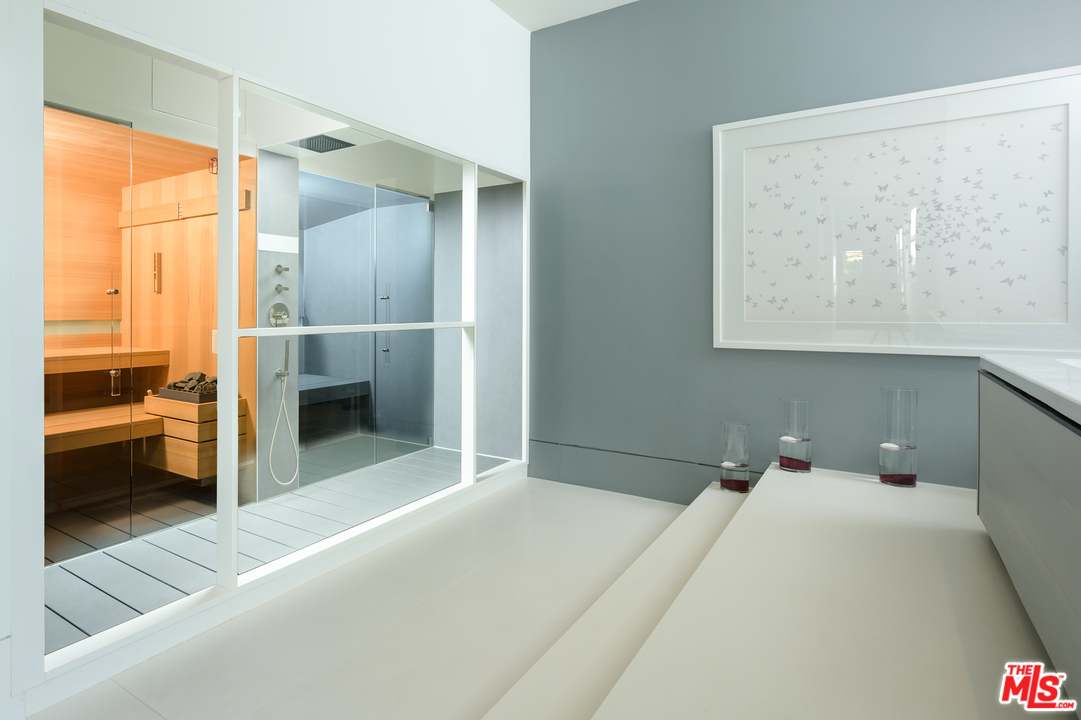 10701 Bellagio Road Los Angeles, CA 90077 - Photo 34 of 36 a bedroom with a bed and a view of en suite bathroom