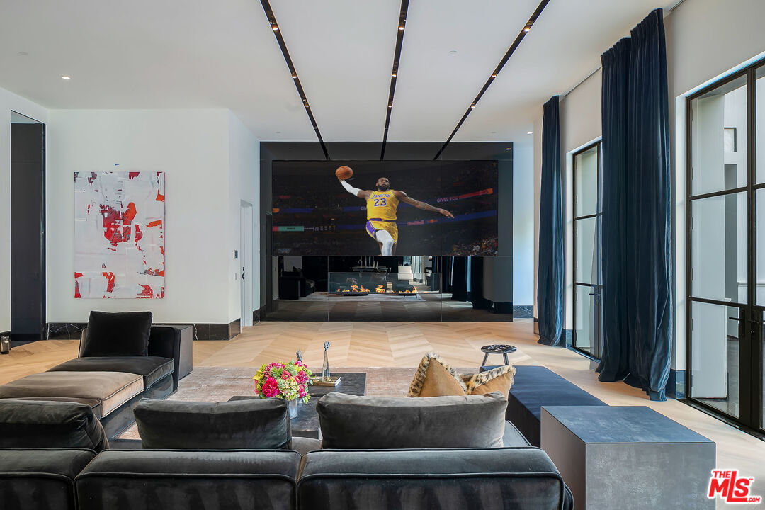 10701 Bellagio Road Los Angeles, CA 90077 - Photo 10 of 36 a living room with furniture and a flat screen tv