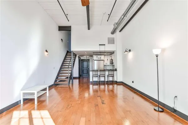 a view of empty room with wooden floor