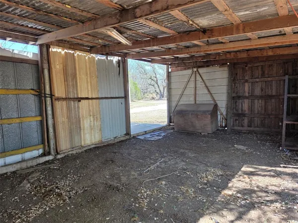 a view of empty room with wooden walls