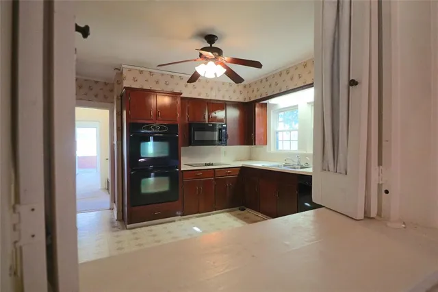 a view of empty room with fireplace and fan