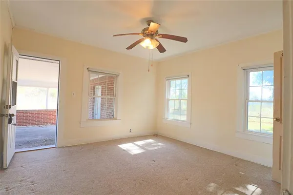 an empty room with windows and closet