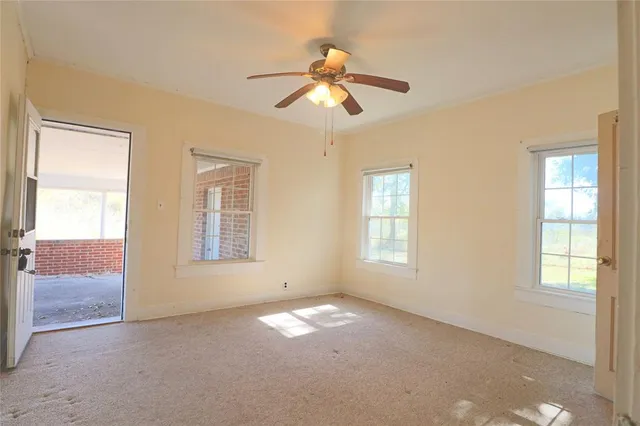 an empty room with windows and closet