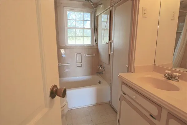 a bathroom with a sink a mirror and a bathtub