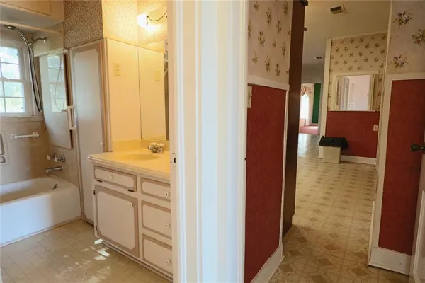 a view of empty room with window and ceiling fan