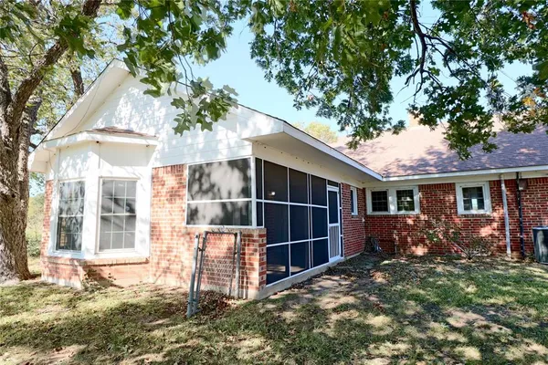 a view of a house with backyard garden and fire pit