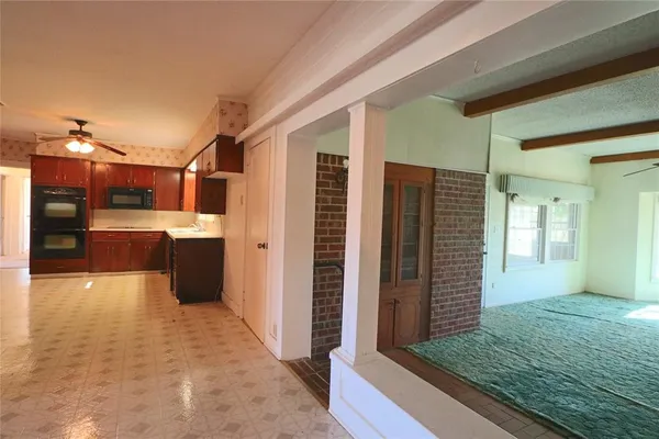 a kitchen with a sink and chandelier