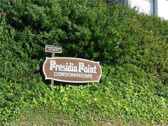 a sign of golf club on a tree