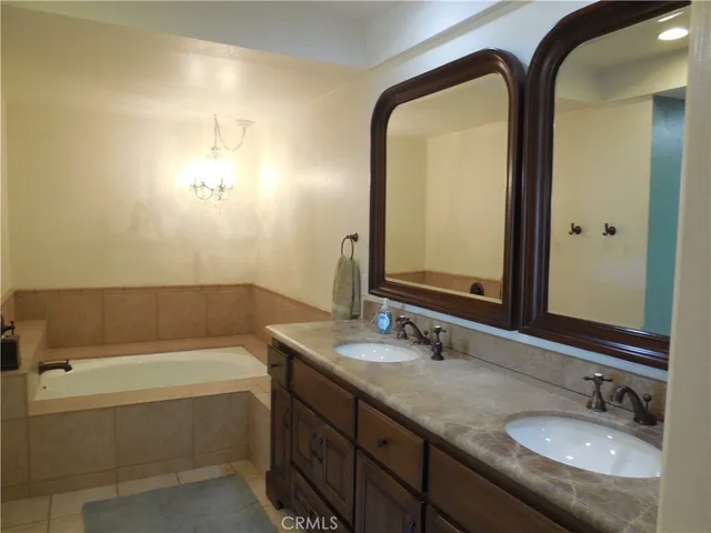 a bathroom with 2 sink tub and a mirror