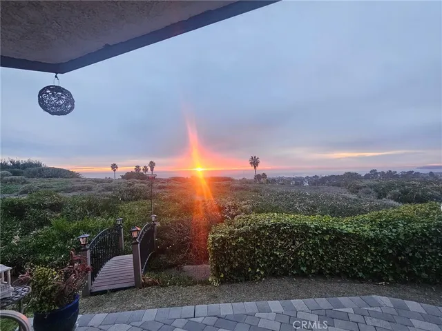 a view of a street with a couple of cars parked in front of it
