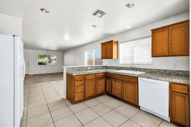 a kitchen with stainless steel appliances granite countertop a sink and a granite counter tops