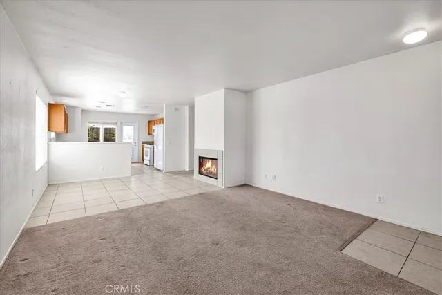 an empty room with windows and entrance