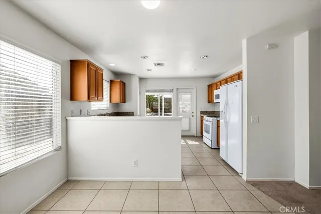 a view of a kitchen with a refrigerator cabinets and a window