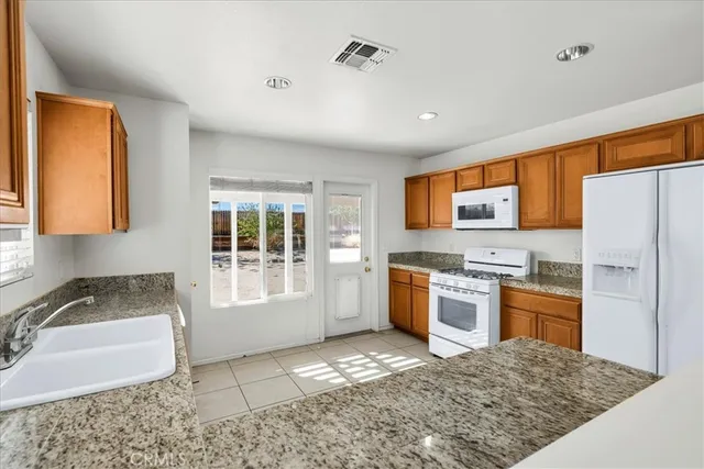 a kitchen with a sink stove and refrigerator